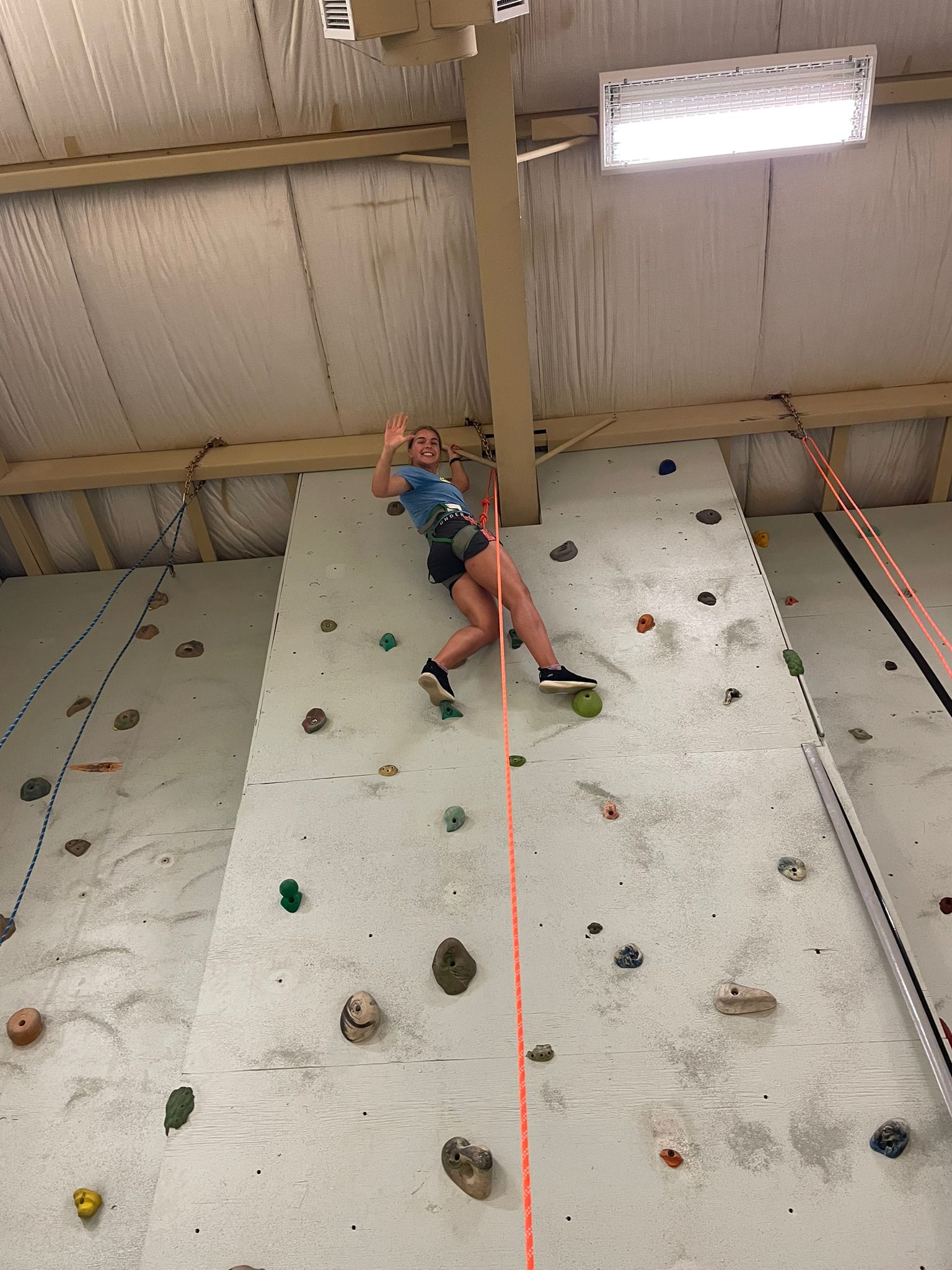 AT the top of the indoor climbing wall