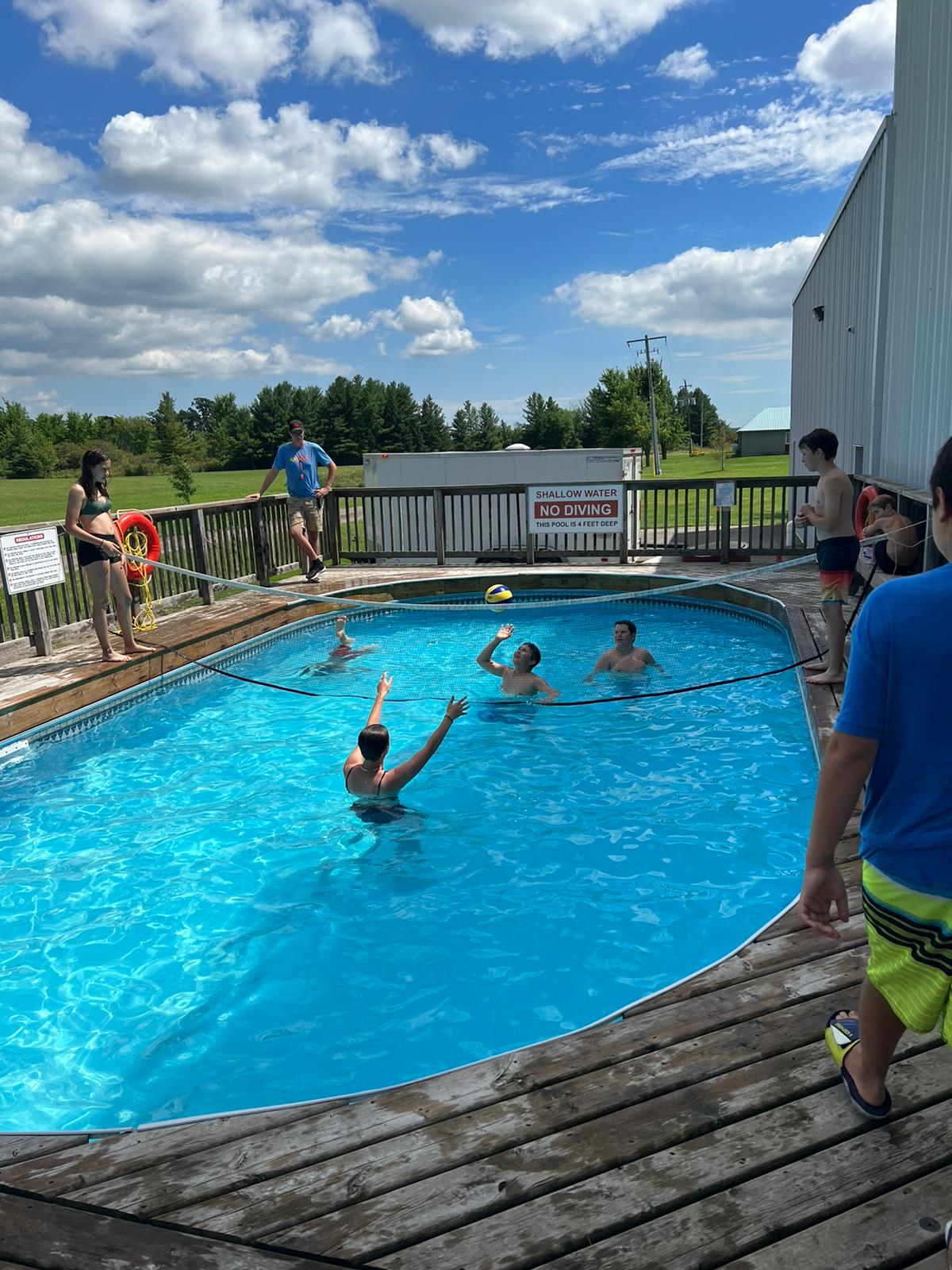 Campers play volleyball in the pool